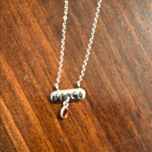 Silver Peace Necklace with Red Gemstone